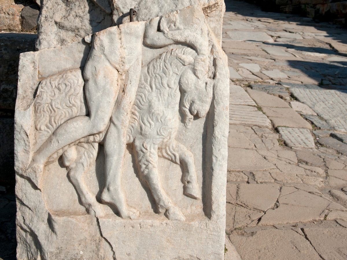 Marble relief of Hermes pulling a ram by the horns, carved on a pedestal standing right beside the paving of Curetes Street in Ephesus