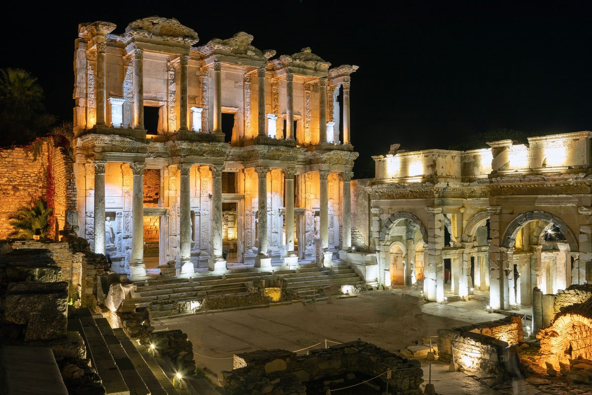 The Library of Celsus and the gate of Mazaeus and Mithridates floodlit at night at Ephesus, against a black sky